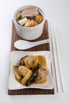 Chicken and herb soup in pot, Chinese food style.