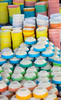 Inexpensive dishware of different colors on the eastern market