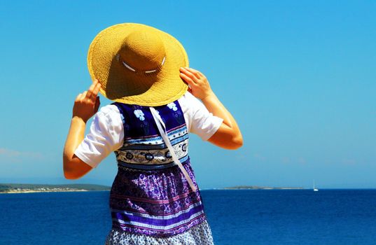 Young woman is observing the sea.