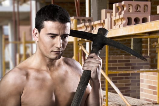 Male worker with shovel and bricks