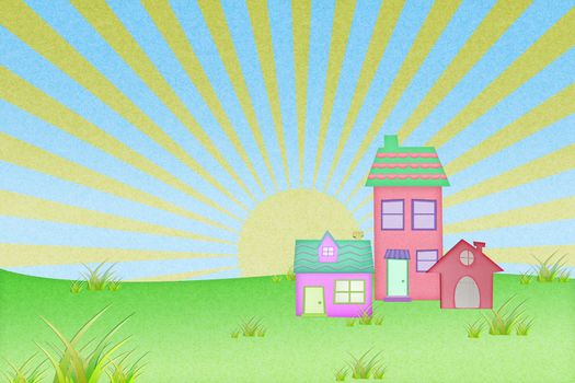 house from recycle paper with grass field and sun set background