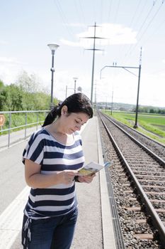 Young female lost looking the map finding the right direction