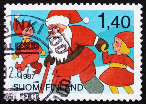 FINLAND - CIRCA 1987: a stamp printed in the Finland shows Santa Claus and Youths, Christmas, circa 1987