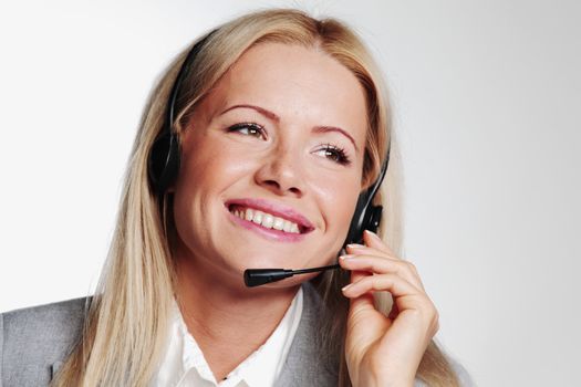 business woman in a headset on a gray background