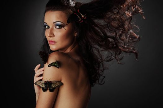woman and butterfly on black