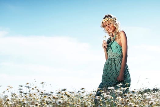 beautiful girl  in dress on the daisy flowers field 