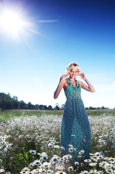  beautiful girl  in dress on the sunny daisy flowers field 