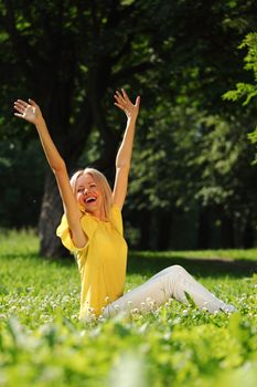 happy woman sitting on grass