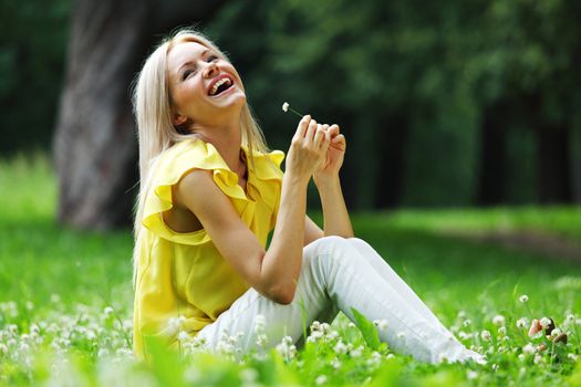 woman dachshund in her arms on grass