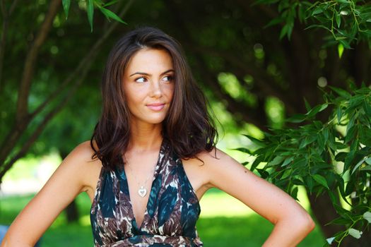girl on a background of green trees