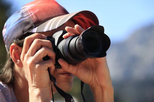 Man with photo camera taking pictures