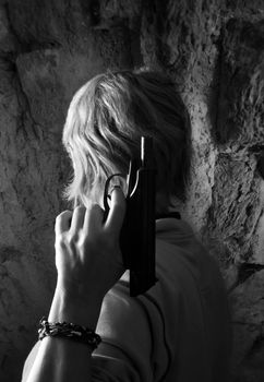 The woman with a pistol on a background of a wall
