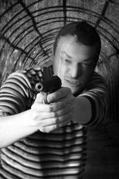 Black dressed man with gun in the tunnel