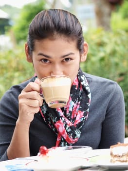Asian woman drinking a coffee