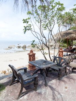 wood chairs on tropical beach
