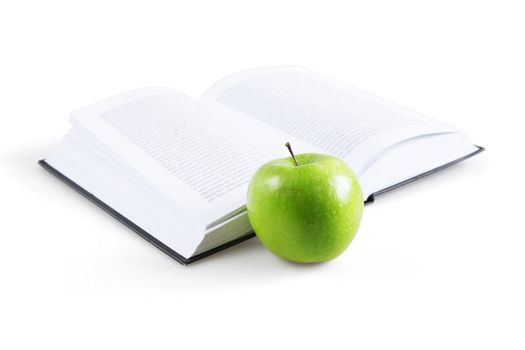 art book and ripe green apple