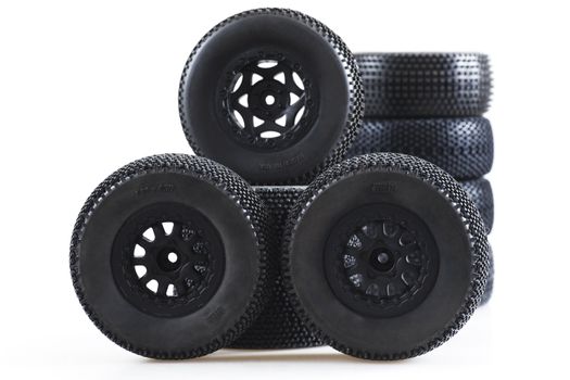 heap of wheels for radio-controlled models on a white background