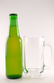 bottle and glass of beer on white background