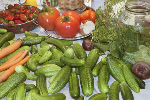 A variety of vegetables are on the kitchen table