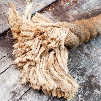 Closeup of frayed end of thick sisal rope showing the structure of the natural fibres threaded together to form a strong hawser