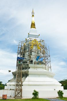 Stock Photo - Historic red stupa in thailand, against blue sky