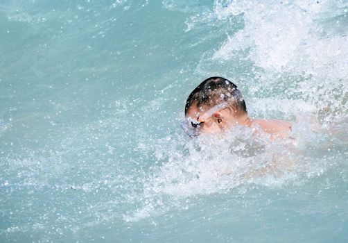 Young boy swimming in the sea