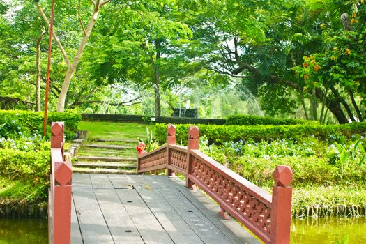 Stock Photo - Nice old wooden bridge in park at summertime.