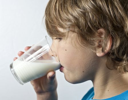 Young boy drinking milk from a glass