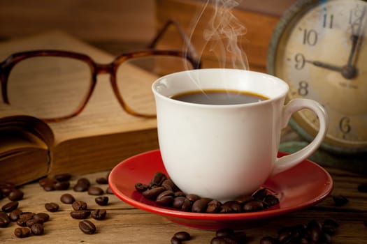 coffee cup and coffee beans on dark background