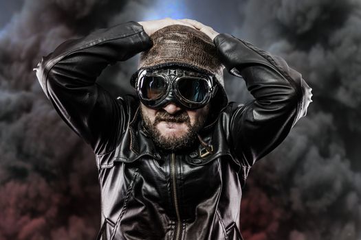 pilot with glasses and vintage hat over background explosion