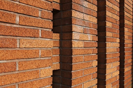 Perspective view of a tan brick wall built in columns