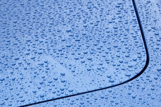 raindrop covered blue vehicle panel abstract