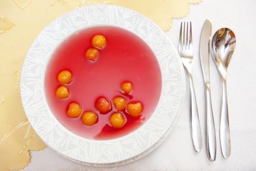 Fruit soup on the white plate