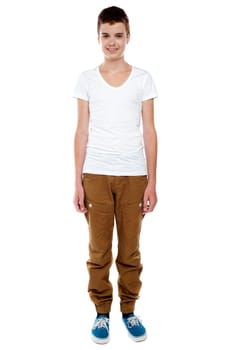 Full length shot of trendy young caucasian boy posing against white background