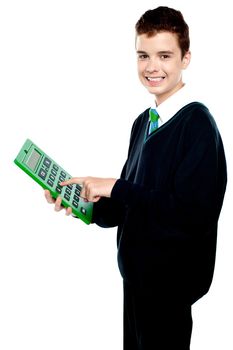 Charming smiling school kid operating calculator and looking at camera