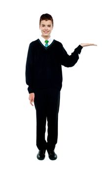 Full length shot of boy presenting copy space isolated over white