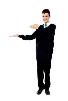 Young boy presenting copy space. Full length portrait