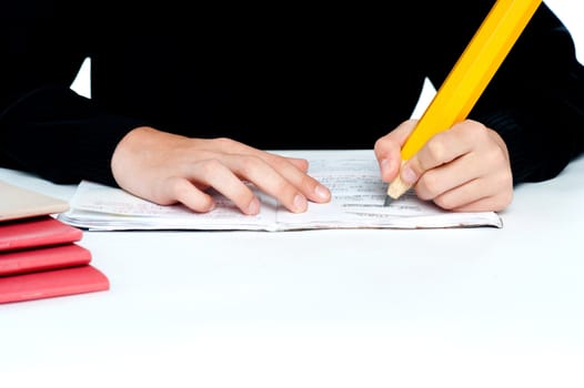 Closeup shot of school boy doing homework over white background