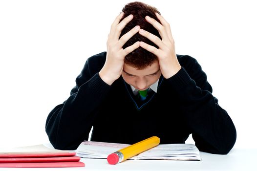 Confused student holding his head in classroom. All on white background