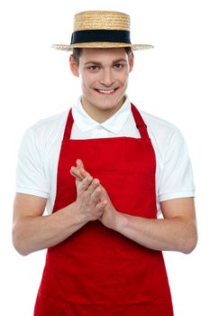 Young male chef wearing hat isolated over white