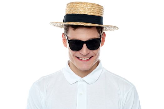 Closeup shot of smiling young man in hat. Vacations mood