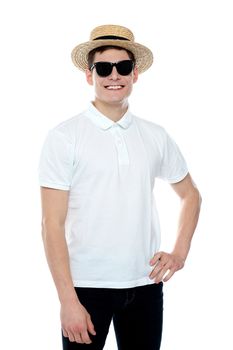 Man smiling with hand on his waist wearing hat against white