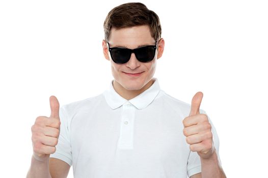 Handsome guy gesturing double thumbs up wearing goggles
