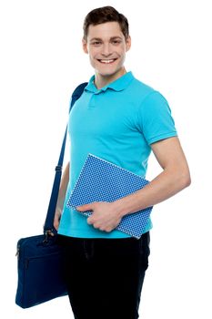 Smiling guy holding notepad and laptop bag smiling at camera