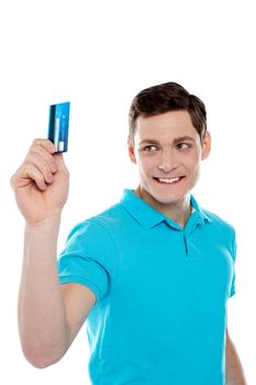 Handsome young man holding and looking  at credit card