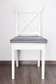 White chair on the white wall background