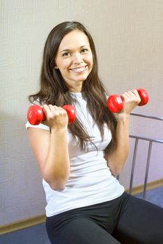 happy beautiful young brunette girl working out