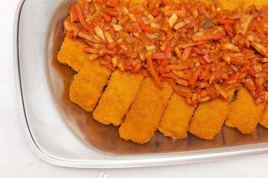 Fish with carrots on the silver plate