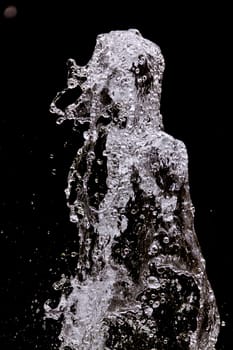 Abstract shape created by splashing water with the shape of a woman with her hair back