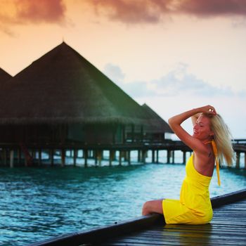 woman on tropical beach house back on the background